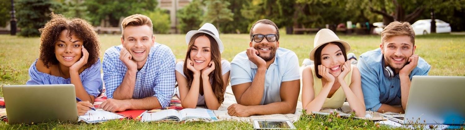 students-lying-on-grass-with-books